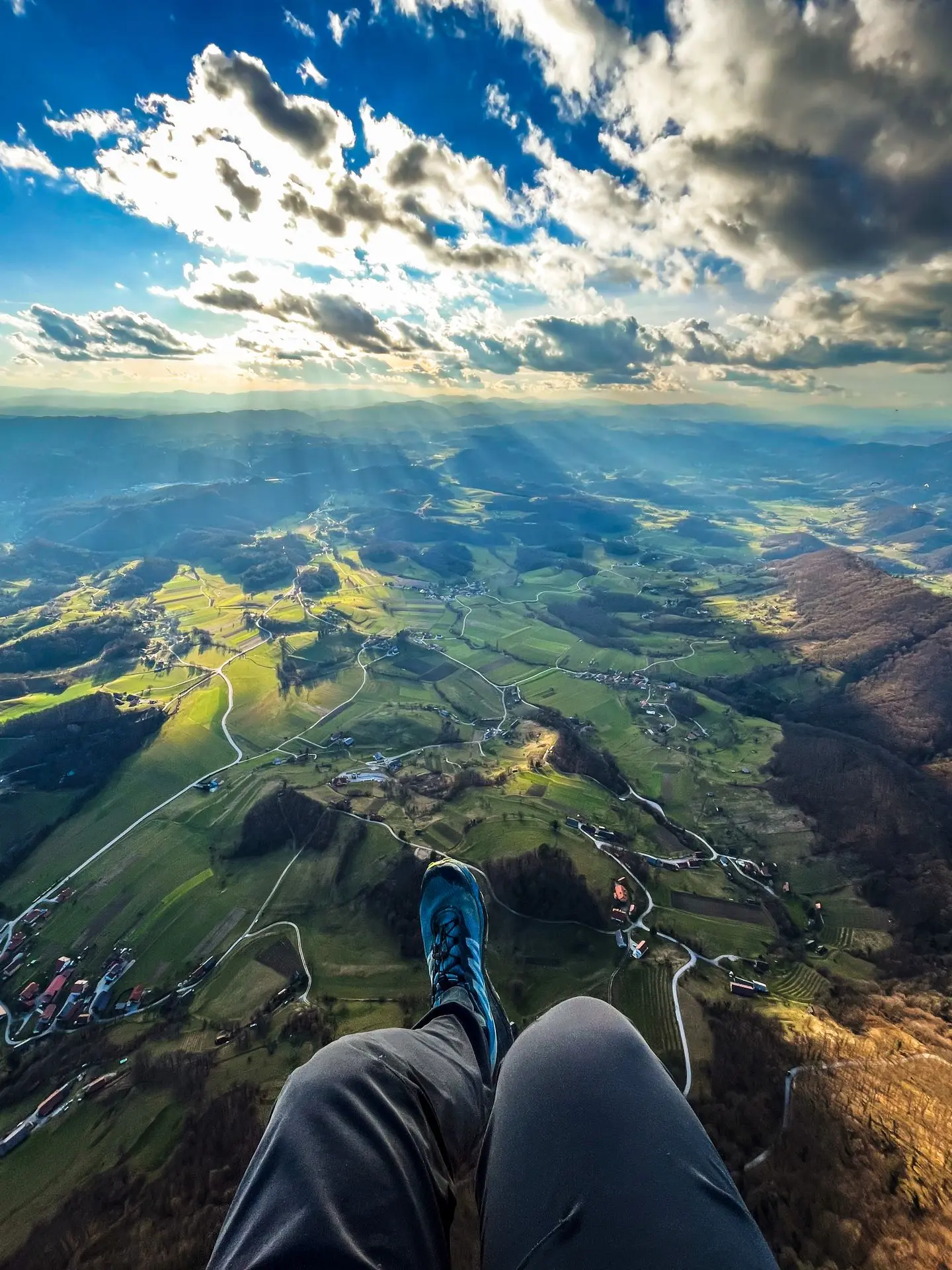 Paragliding above the clouds in Slovenia at sunset